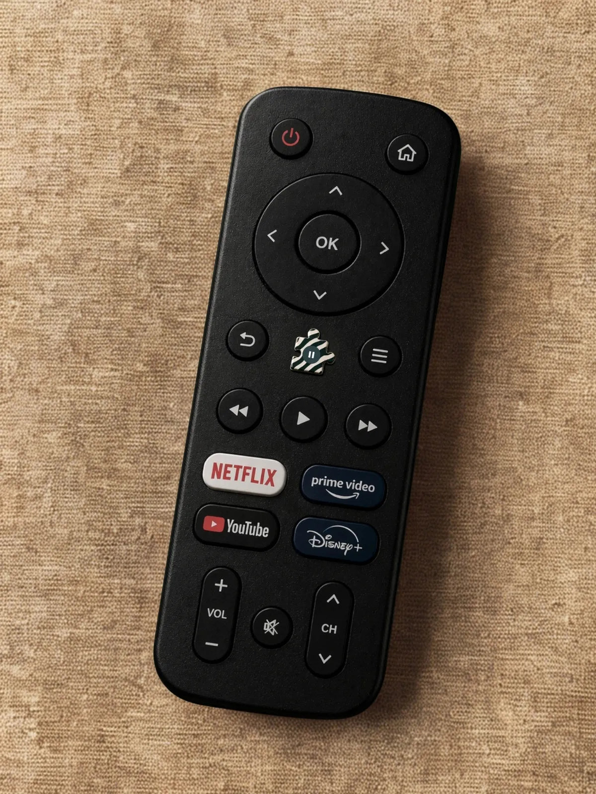 Télécommande avec un bouton pause symbolisé par une pièce de puzzle, illustrant le besoin de ralentir et d’apaiser le mental grâce à une activité calme comme le puzzle pour adulte zebresque